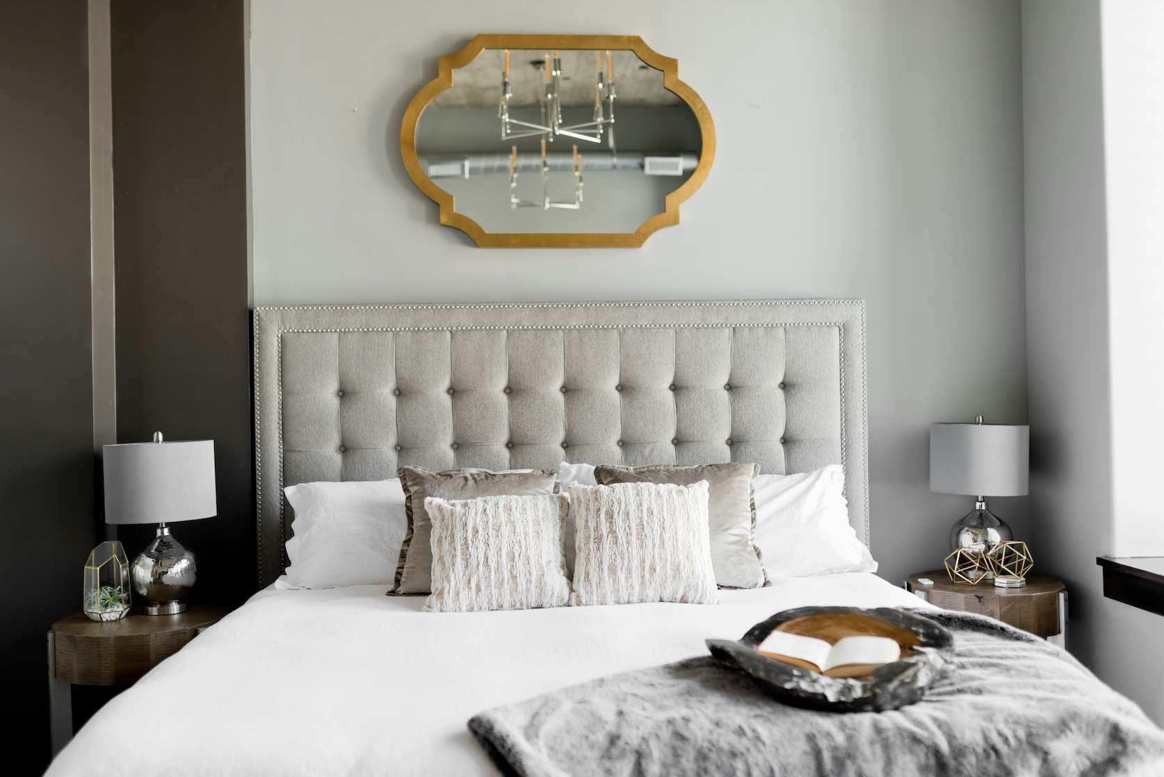 bedroom with headboard and mirror